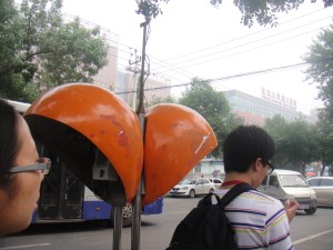 These are what the telephone booths in Beijing look like. Looks like orange pods lol